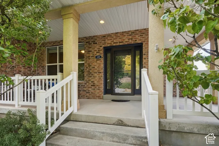 Brick exterior with concrete steps and porch