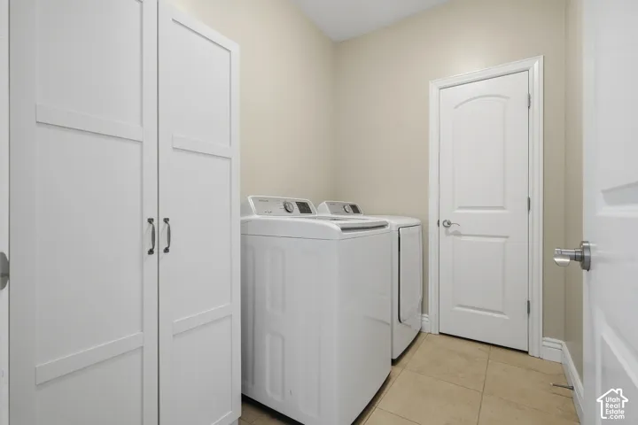 White paneled cabinetry, light neutral wall paint, and tiled flooring