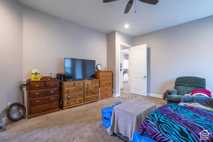 Recessed lighting, ceiling fan, and carpeted flooring