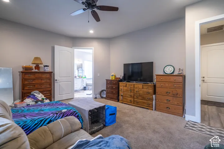 Recessed lighting, ceiling fan, neutral wall paint, white interior doors, and carpet flooring