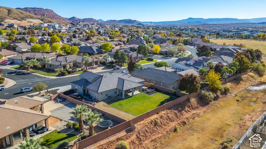 Single-story residence with a covered patio, fenced backyard, and a paved driveway