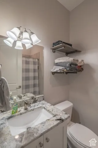 Modern vanity with a rectangular undermount sink, stone countertop, and brushed nickel faucet
