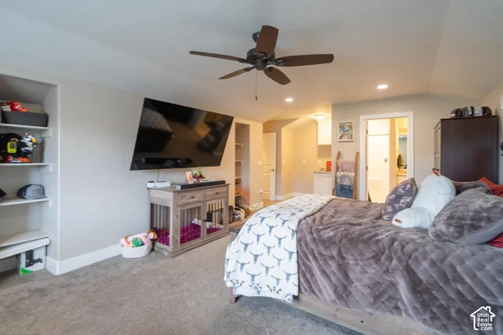 Recessed lighting, ceiling fan, built-in shelving, wood-finish flooring, and a sliding door