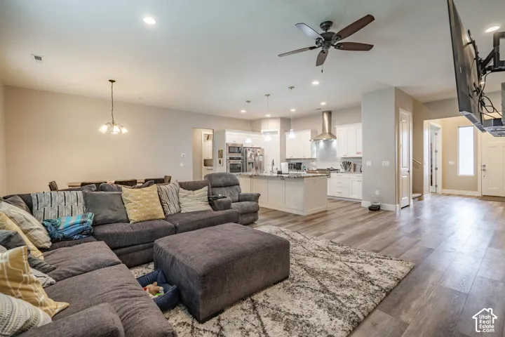 Wood-finish flooring throughout, recessed lighting, and a ceiling fan
