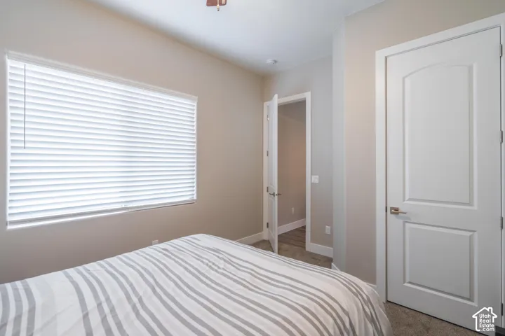 Room with neutral-toned walls, recessed lighting, and a window with horizontal blinds