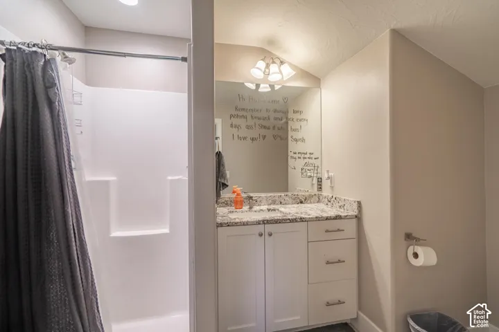 White single-piece shower surround with integrated shelving