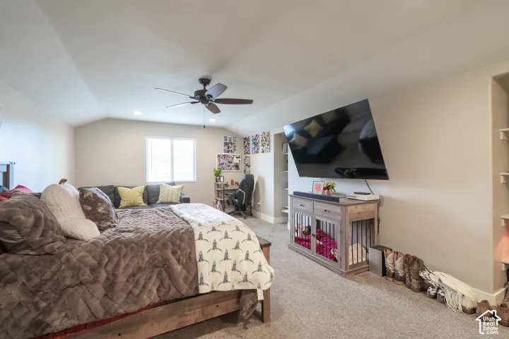 Carpeted room with a vaulted ceiling, recessed lighting, and a ceiling fan