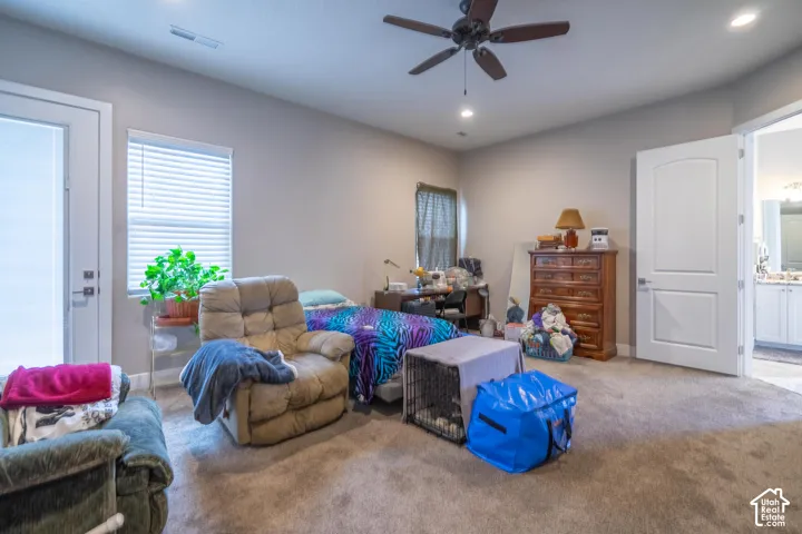 Carpeted flooring, ceiling fan, recessed lighting, and a white interior door