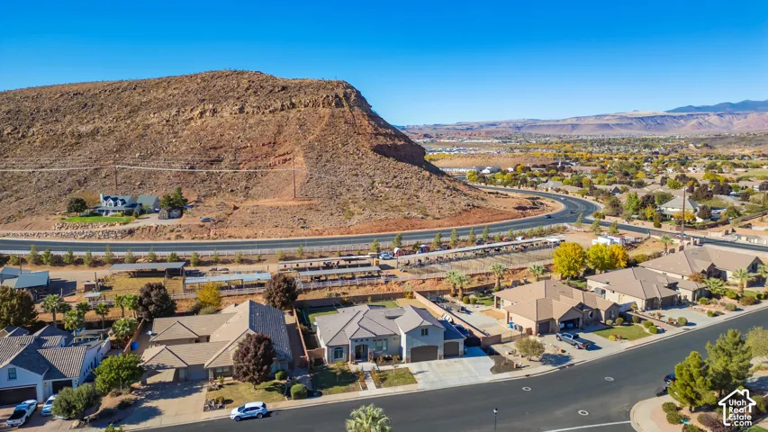 Residential neighborhood with an arid mountain backdrop and a winding road