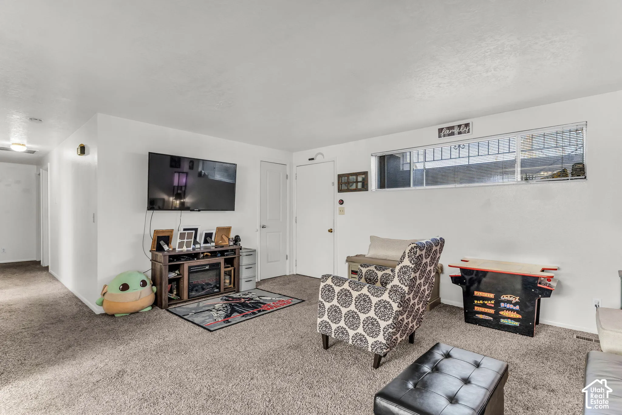 Wall-mounted television with built-in media console featuring an electric fireplace