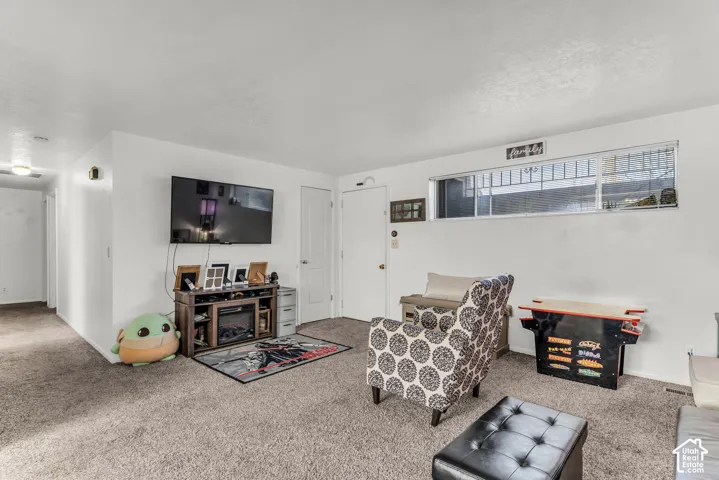 Wall-mounted television with built-in media console featuring an electric fireplace