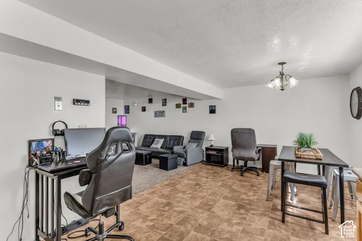 Recessed ceiling, vinyl tile flooring, carpeted area, and overhead chandelier
