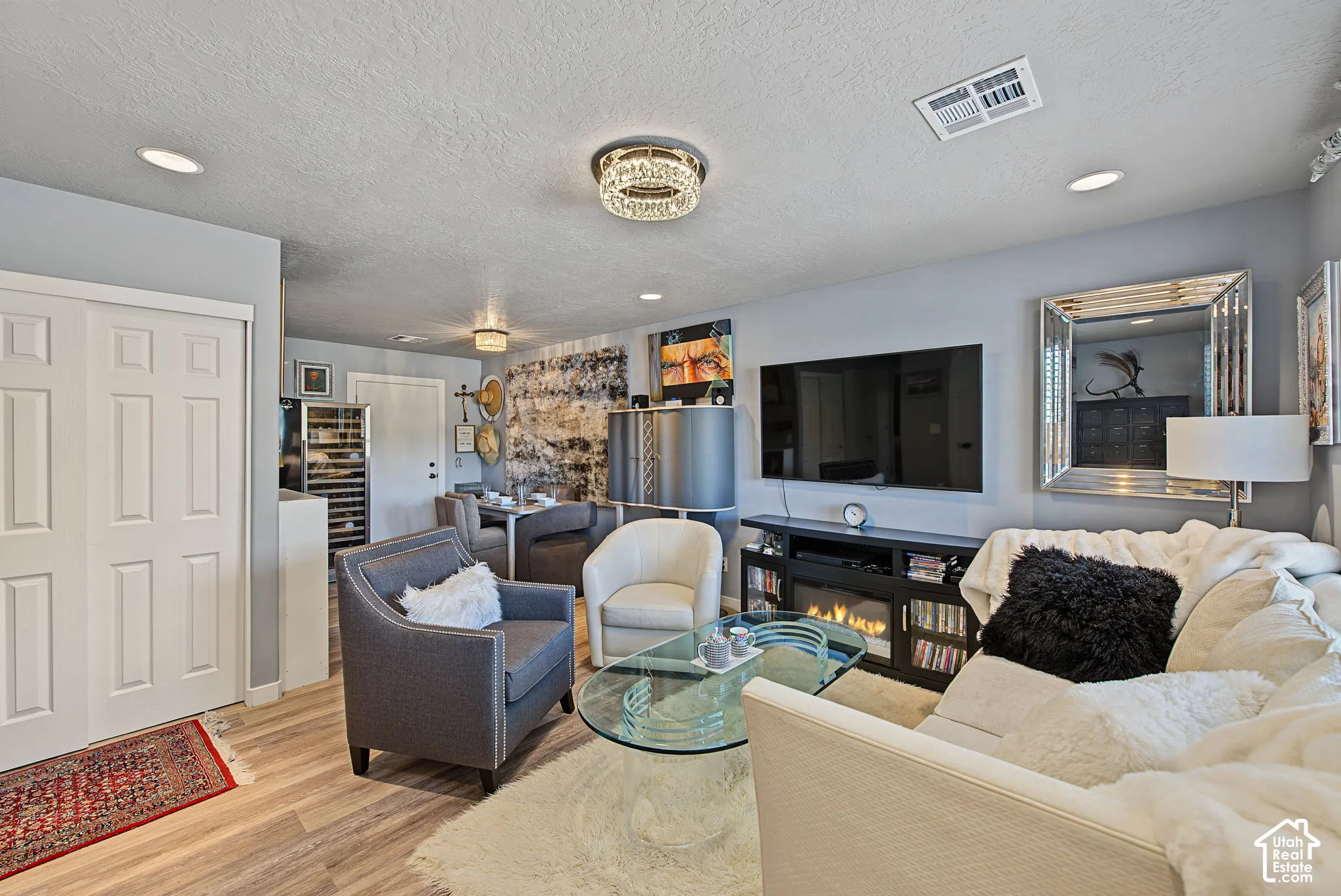 Wood-finish flooring throughout, recessed lighting, and a built-in electric fireplace