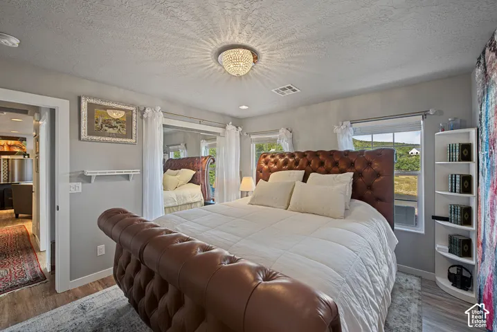 Recessed lighting, wood-finish flooring, and multiple windows