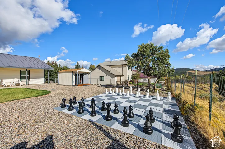 Outdoor oversized chessboard on a gravel surface
