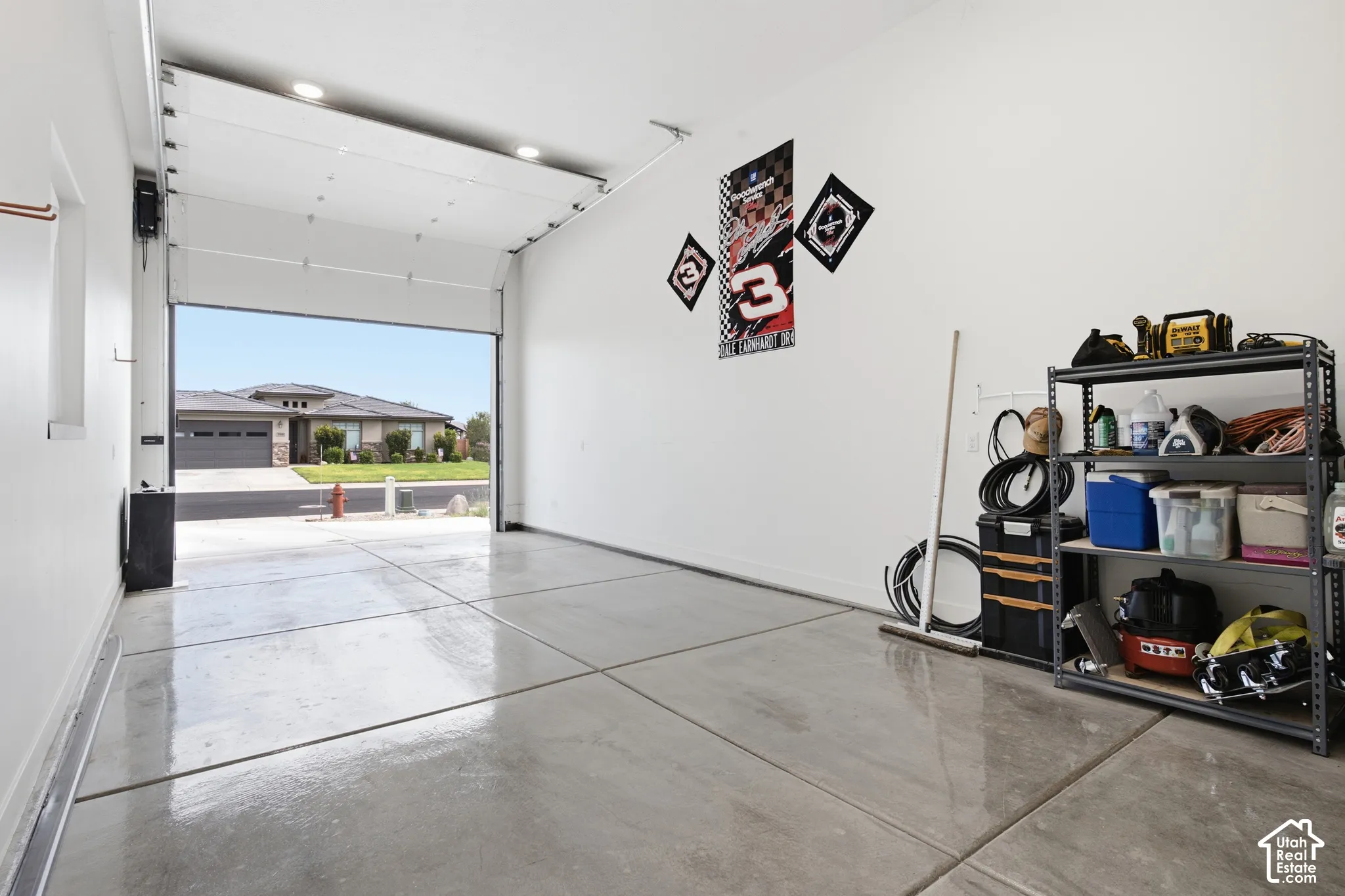 Garage space featuring a roll-up door, recessed lighting, and a polished concrete floor