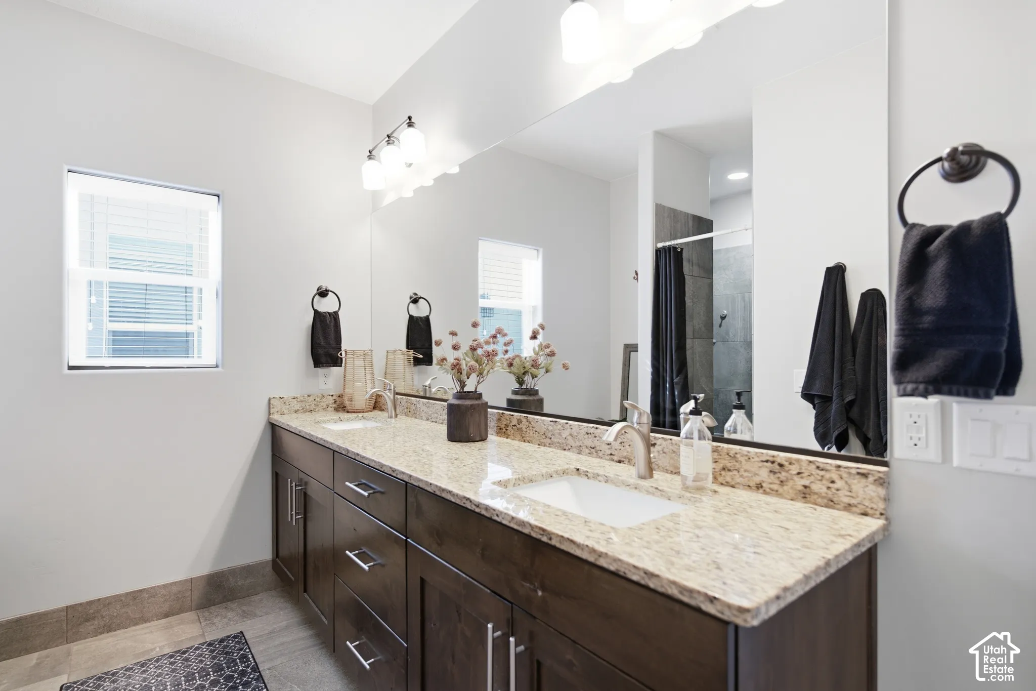 Dual vanity with light-toned countertop, undermount sinks, and brushed nickel fixtures