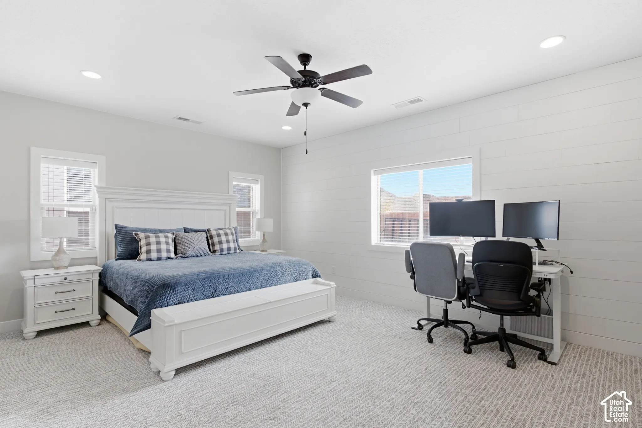 Recessed lighting, ceiling fan, shiplap accent wall, multiple windows, and carpeted flooring