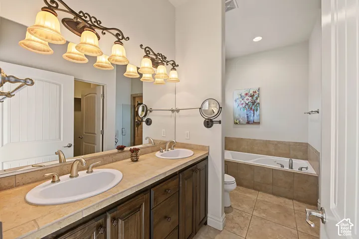 Dual vanity with integrated sinks, wood-finish cabinetry, and a large mirror