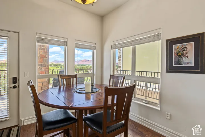 Recessed lighting, multiple windows with blinds, and wood-finish flooring