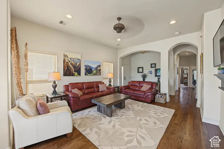 Recessed lighting, wood-finish flooring, arched doorways, and a ceiling fan
