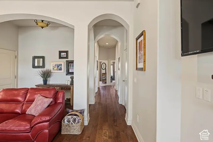 Archway entries, wood-finish flooring, recessed lighting, and white panel doors