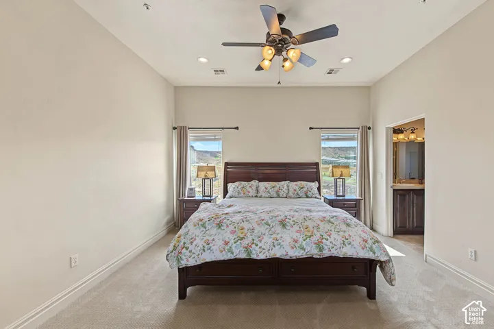 Carpeted bedroom with a ceiling fan, recessed lighting, and a window with blinds and curtains