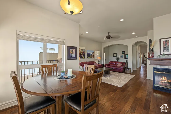 Hardwood-finish flooring, built-in fireplace with wood mantel, arched doorways, recessed lighting, and a private balcony