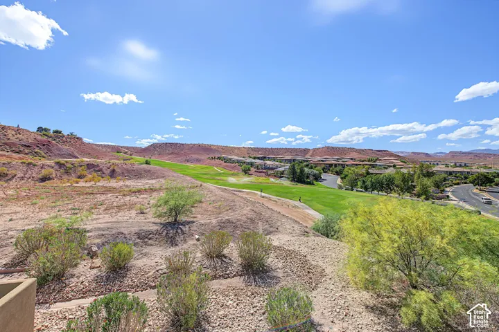 Expansive desert landscape featuring natural rock formations and scattered shrubbery