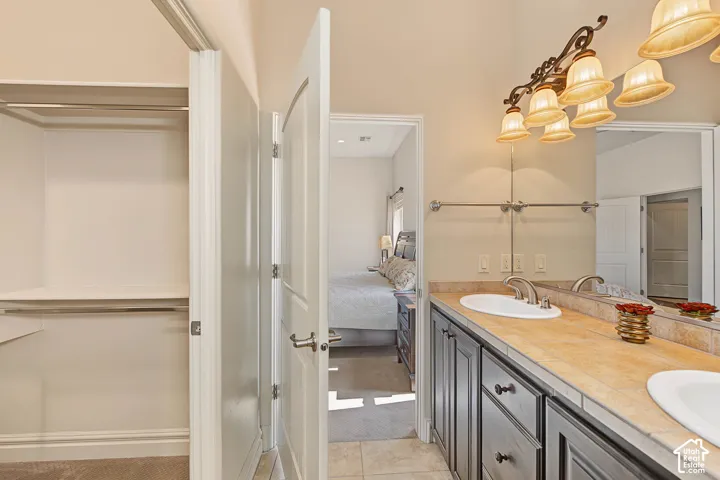 Dual vanity with an integrated sink, substantial mirror, and a wall-mounted light fixture