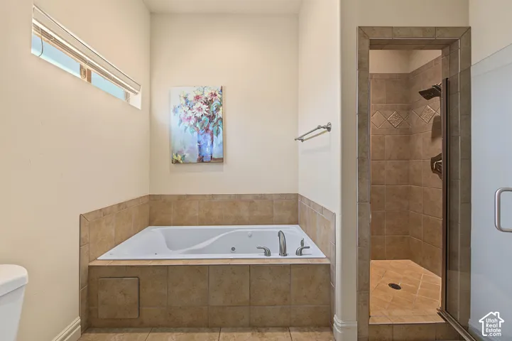 Tiled soaking tub with deck-mounted fixtures