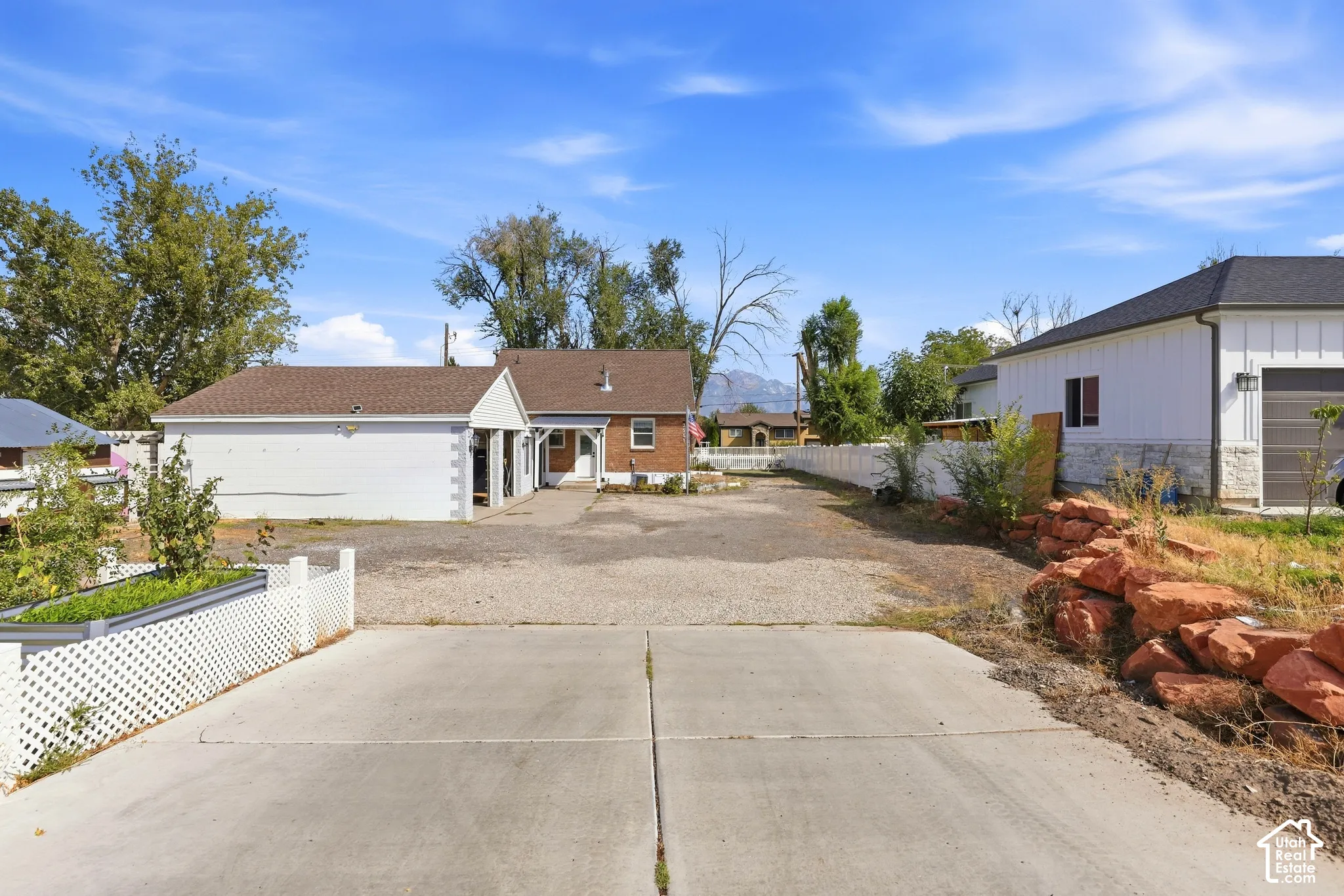 Concrete driveway with a gravel parking area