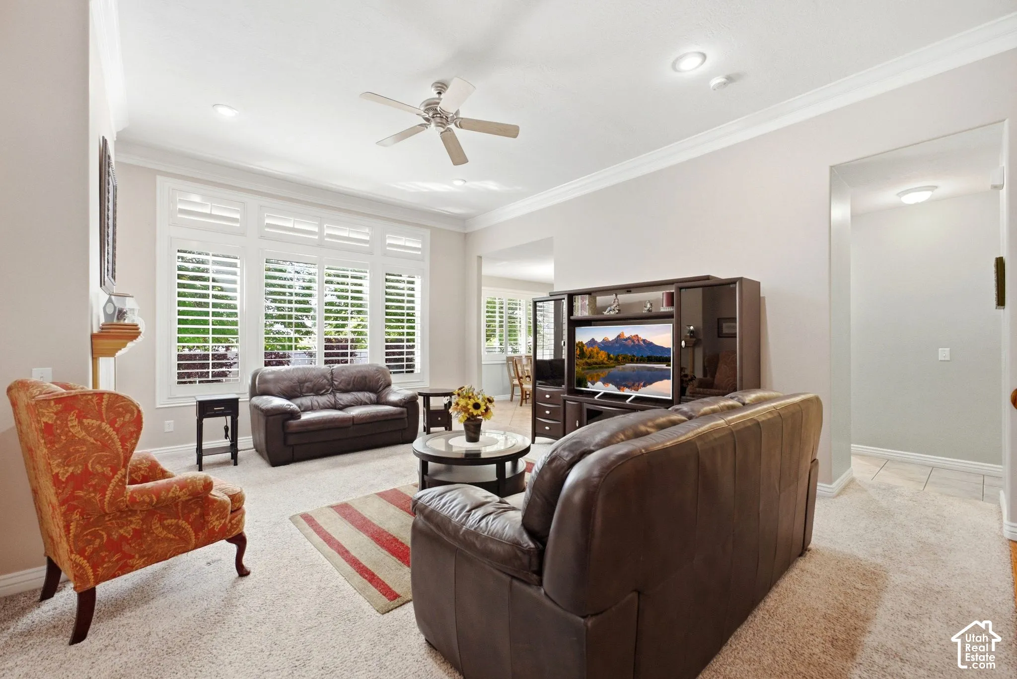 Recessed lighting, crown molding, ceiling fan, and extensive window shutters