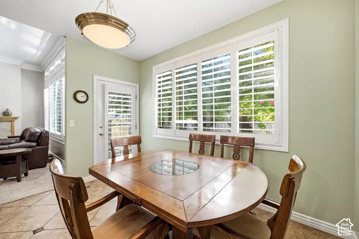 Recessed lighting fixture, light green wall finishes, white window trim, white door trim, and tiled flooring