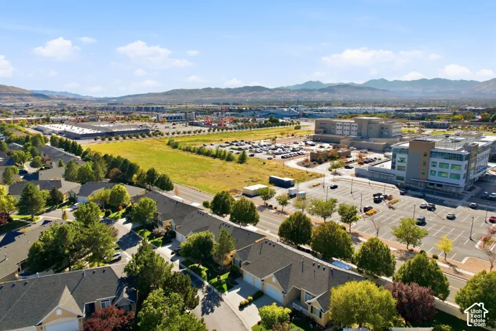 Residential development with a mix of single-story and two-story homes, surrounded by mature trees