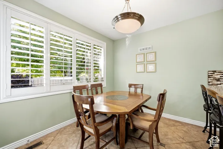 Wood-finish flooring, plantation shutters, and a semi-flush ceiling light fixture