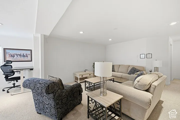 Recessed lighting illuminates the carpeted floor