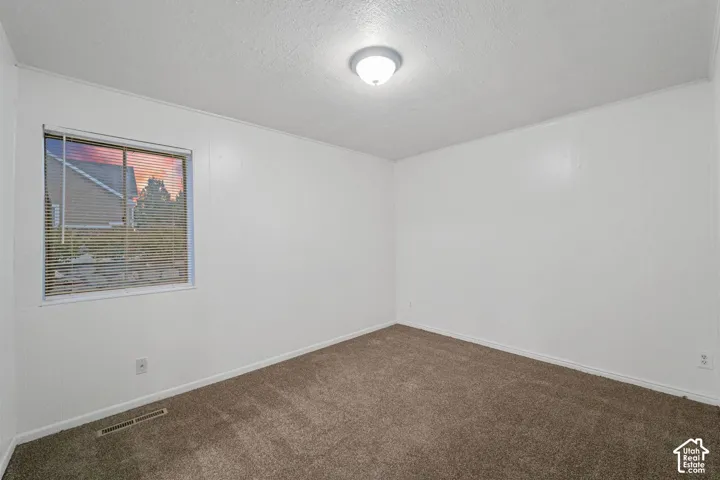 Neutral wall paint and brown carpeting