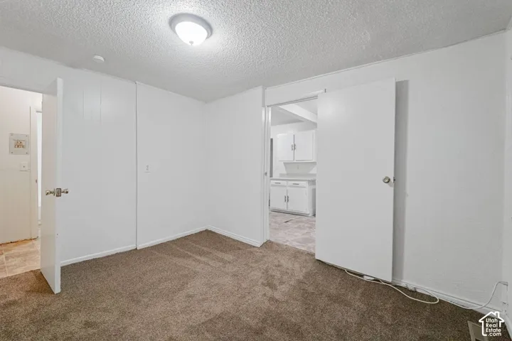 Recessed ceiling light fixture and brown carpet flooring