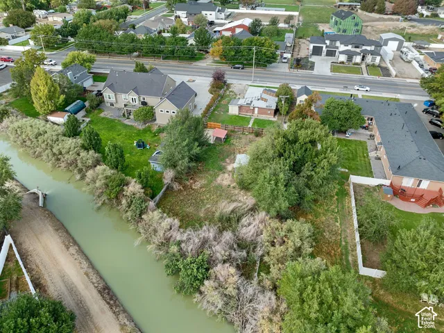Expansive property featuring a canal, mature trees, and established landscaping