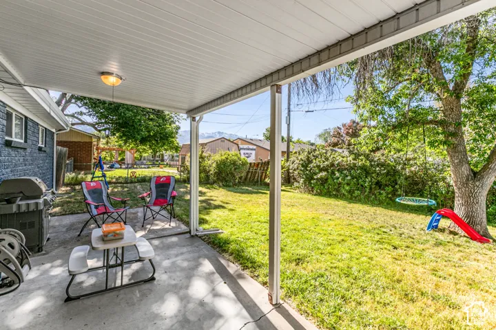 Covered patio featuring an integrated ceiling light and concrete flooring