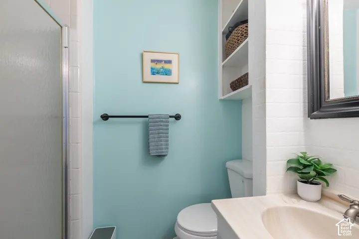 White tiled shower with glass enclosure