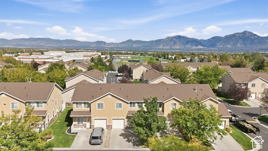 Townhome community with mountain scenery, mature trees, and residential streets