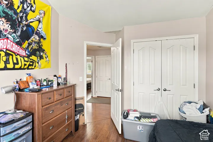 Warm-toned walls with wood-finish flooring, featuring a double-panel closet door and traditional door hardware
