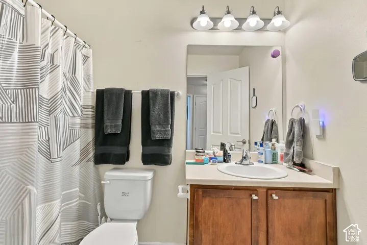 Single vanity with an integrated sink and wood-finish cabinetry