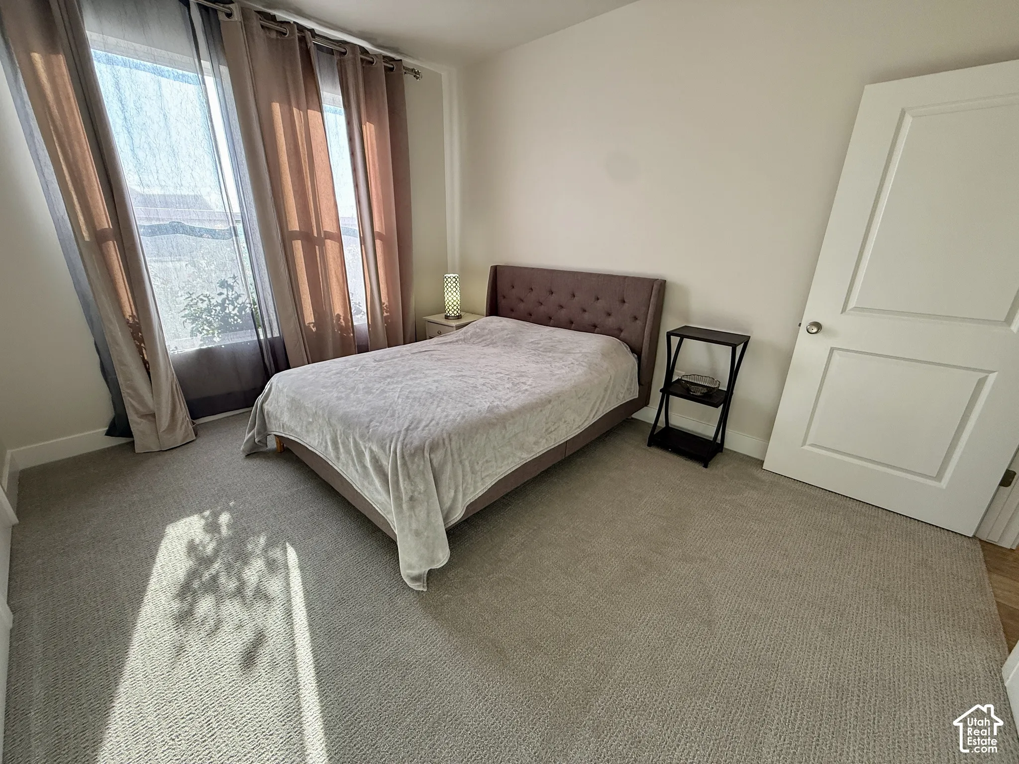 Wall-to-wall carpeting and white walls