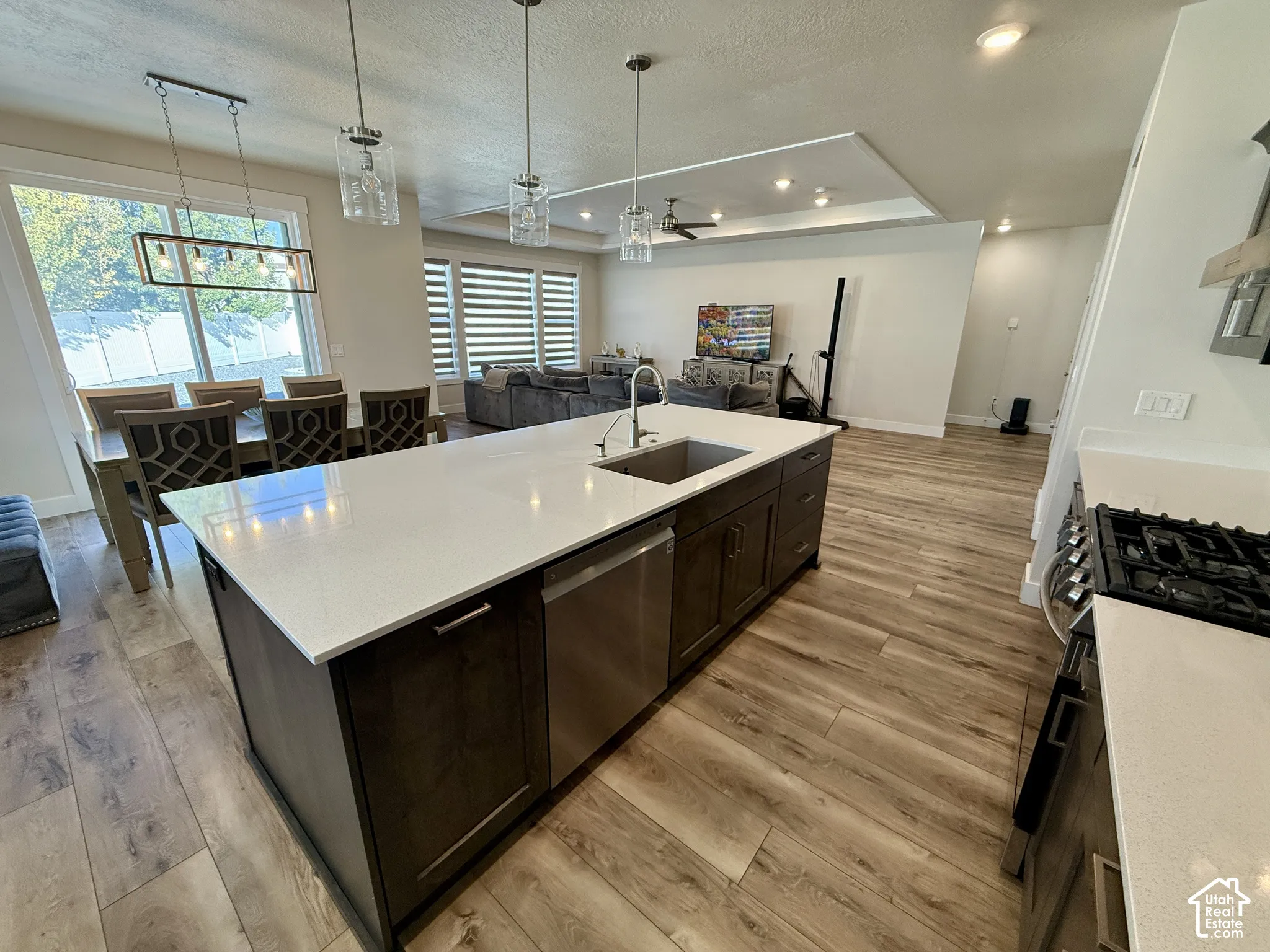 Kitchen island featuring a stainless steel sink and dishwasher