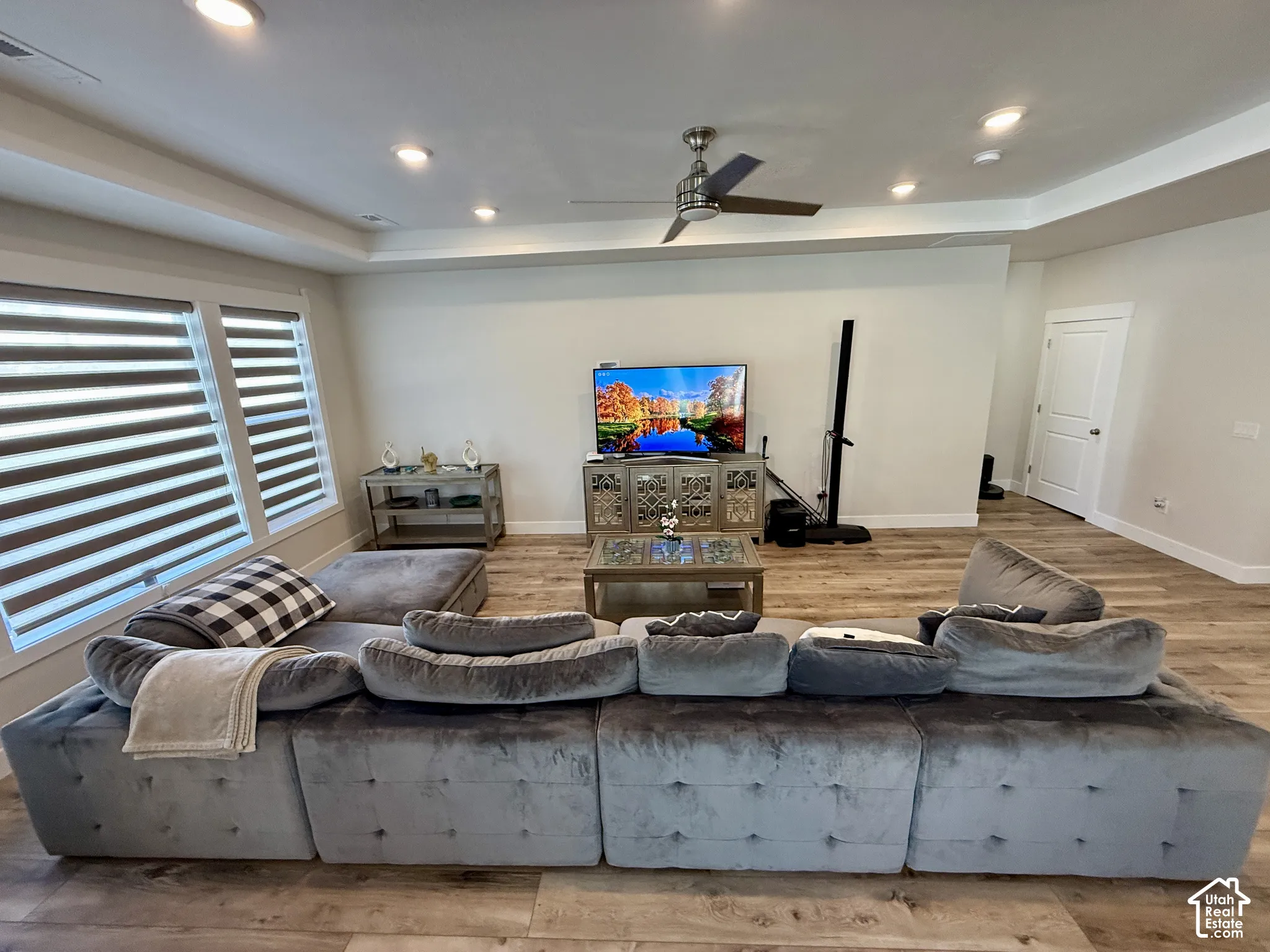 Wood-finish flooring throughout, recessed lighting, and a ceiling fan