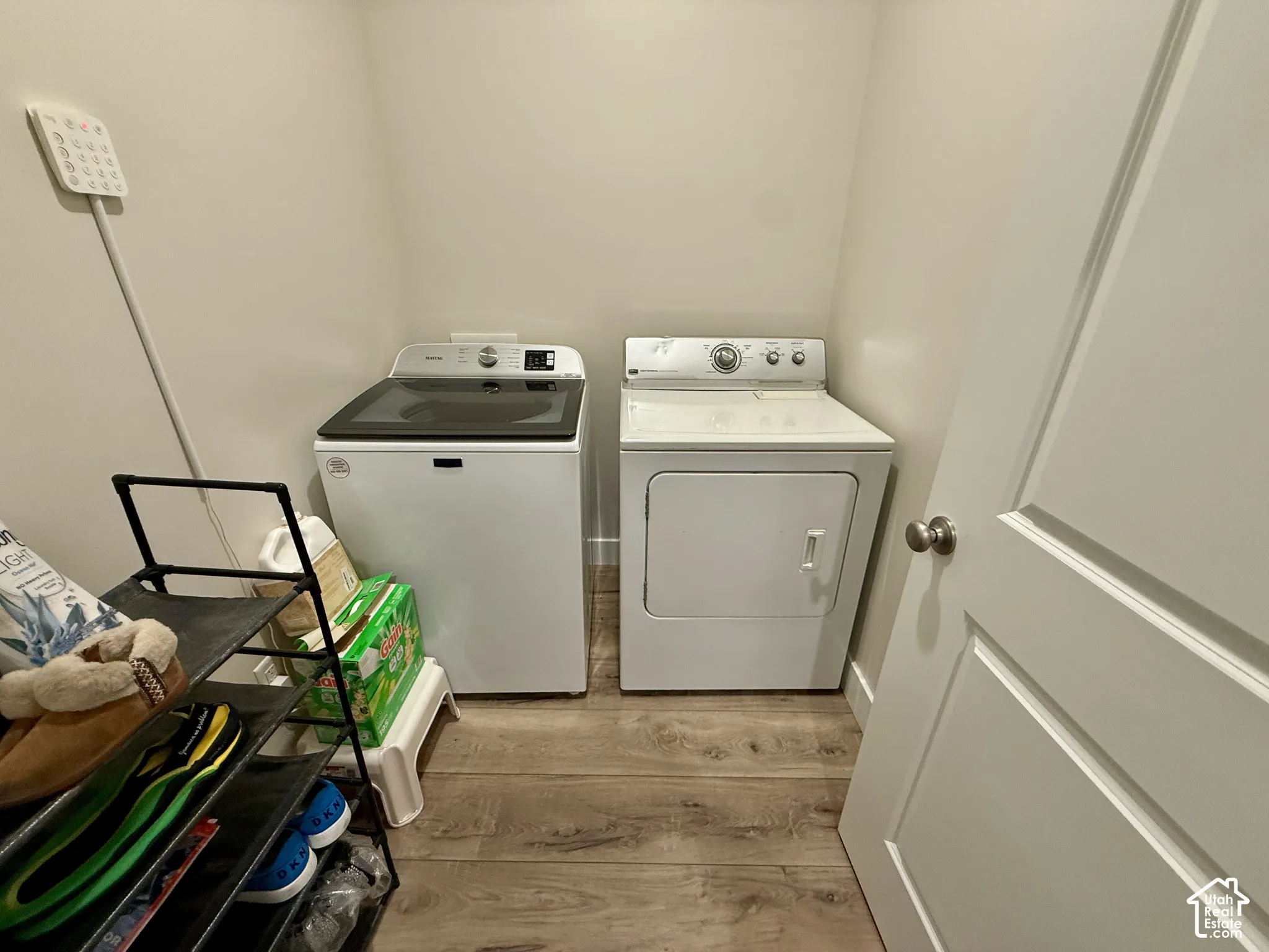 Dedicated laundry area with wood-finish flooring