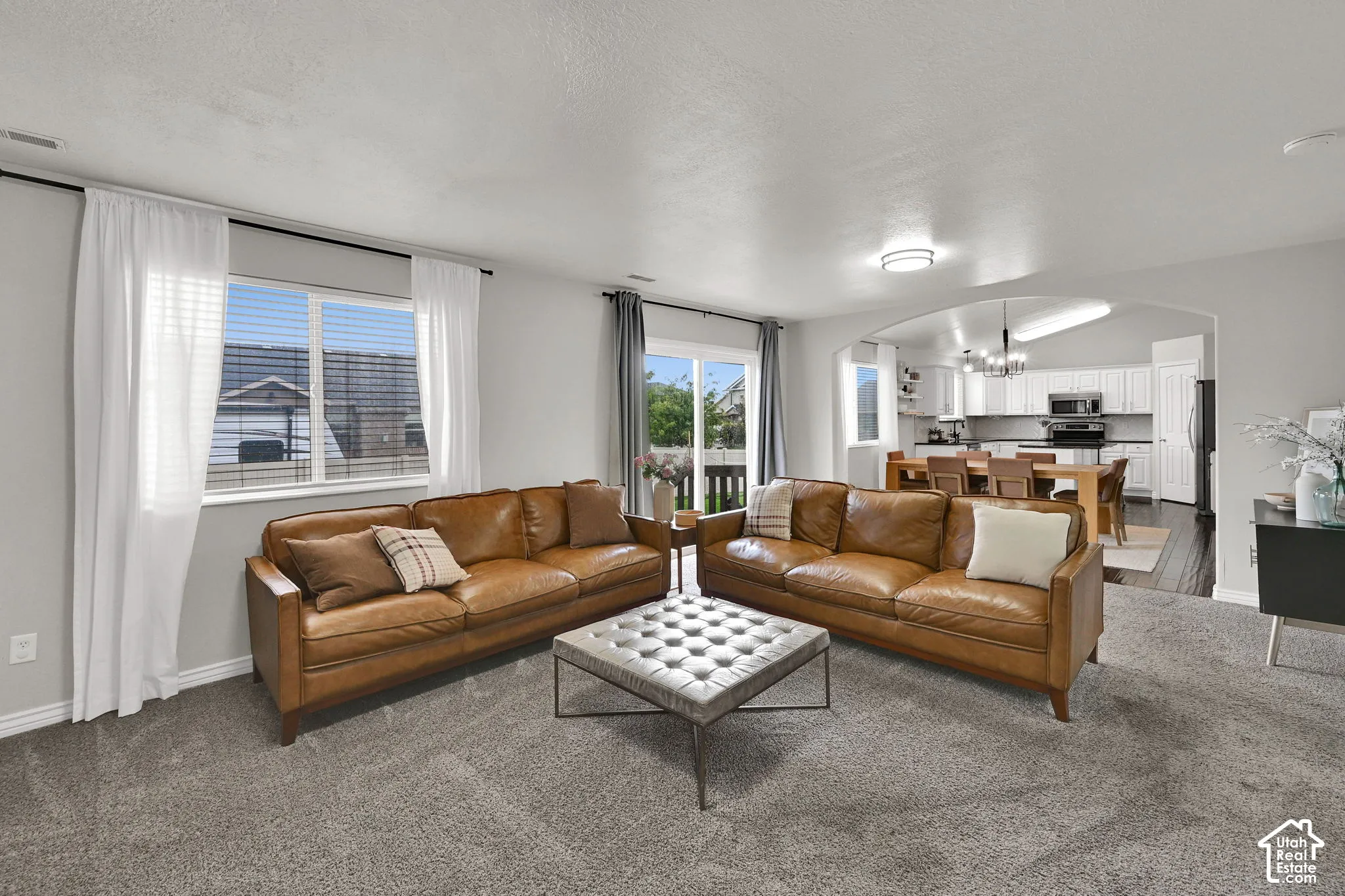 Plush carpeting, sliding glass door, recessed lighting, and large dining area